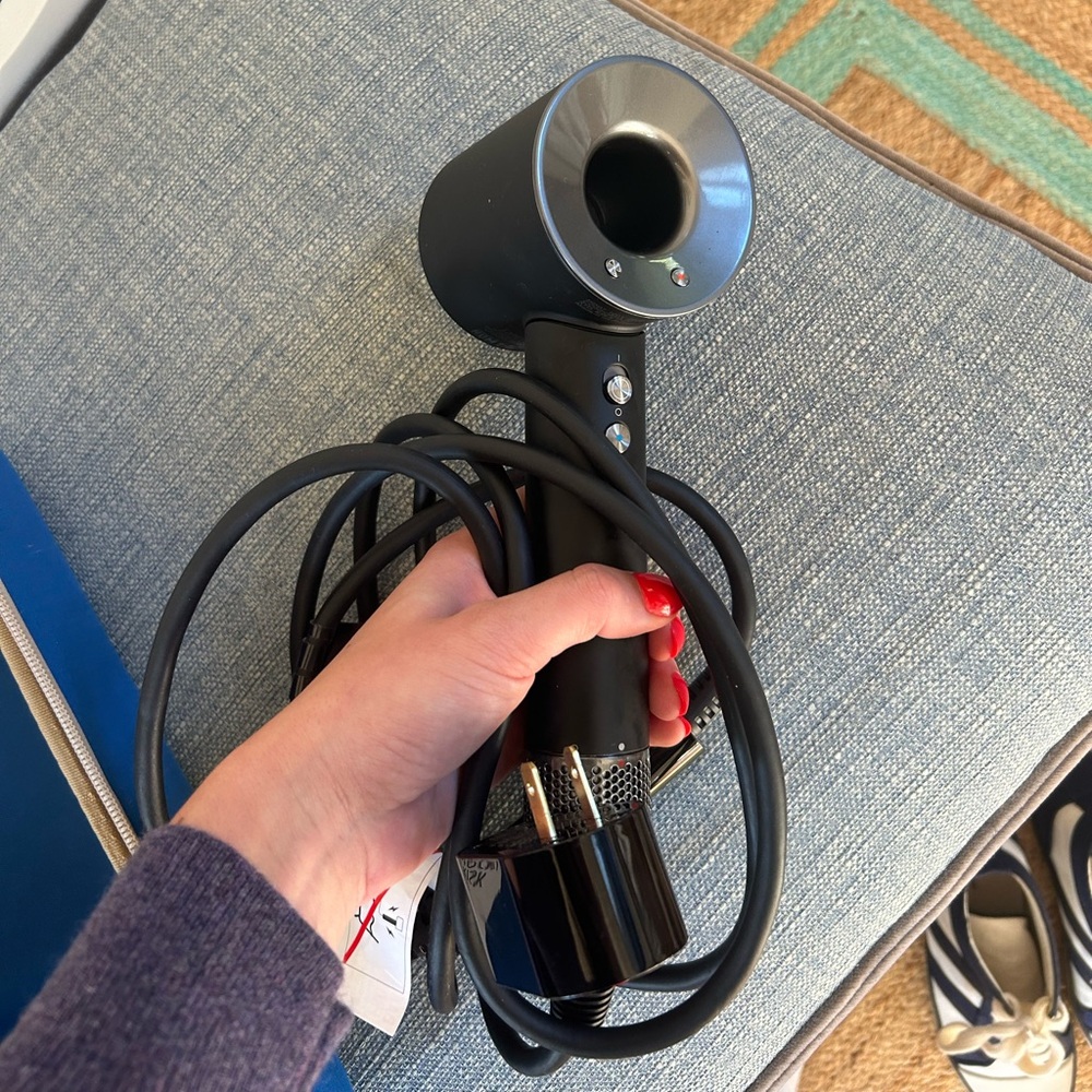 Dyson hair dryer never used. Comes with 3 separate attachments